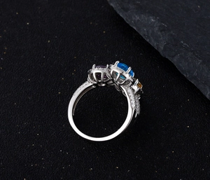 Detailed macro view of a three-stone 925 silver ring featuring colorful oval gemstones
