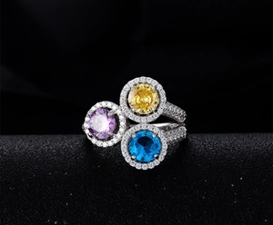 Macro detail of 925 silver ring featuring three colorful round-cut gemstones in a cluster