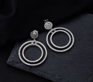 Macro detail of silver S925 drop earrings with pave micro-set cubic zirconia crystals