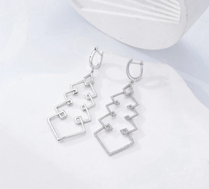 Detailed macro view of S925 sterling silver long geometric cascading drop earrings