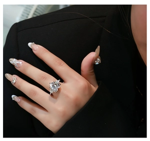 Close-up of a luxury 925 silver ring featuring a large heart-shaped pink diamond and side stones