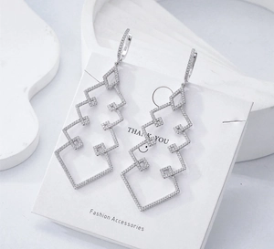 Detailed close-up of S925 sterling silver geometric earrings with sparkling zircon stones