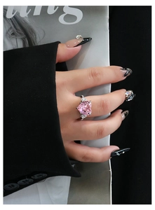 Macro shot of 12x12mm pink heart-shaped crystal ring with silver settings on model
