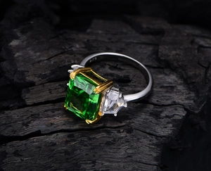 Macro shot of 925 sterling silver stamp on a three-stone emerald cut green carbon diamond ring