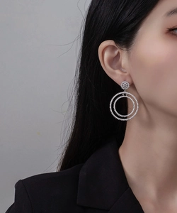 Close-up of double hoop earrings with cubic zirconia on a model for a professional look