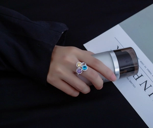 Detailed shot of S925 silver ring featuring three colorful round halo-set gemstones
