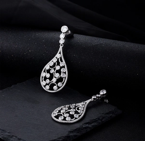 Macro detail of S925 silver water drop earrings with pavé set zircons and hollow patterns