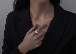 Close-up of S925 silver sunflower ring with micro-pave zircons on a model's hand