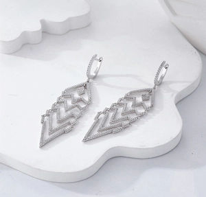 Macro shot of S925 sterling silver long tassel earrings with pave-set V-shape geometry