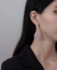 Macro detail of S925 silver teardrop earrings with pave-set sparkling zircon stones