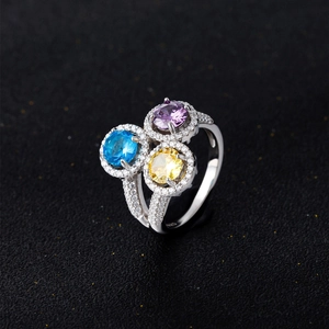 Three-stone 925 silver ring featuring round purple, blue, and yellow colored diamonds