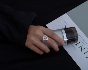 Close-up of S925 silver ring featuring micro-paved flower zircon petals on finger