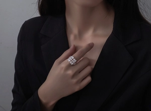 Close-up of multilayer S925 silver ring with rectangular zircon worn by a model
