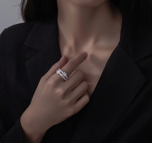 Detail of S925 silver layered ring featuring emerald-cut cubic zirconia on a model