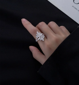 Macro shot of silver ring featuring flower cluster design with marquise cut stones