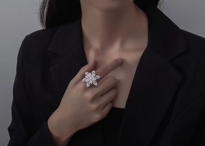 Macro detail of a large silver snowflake cocktail ring with marquise cut sparkling crystals