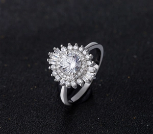 Macro detail of 925 silver ring featuring a double petal sunburst halo and brilliant round stone