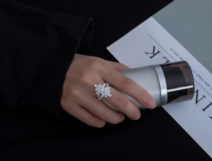 Detailed macro view of S925 silver ring with marquise and round zircon stones on model's hand