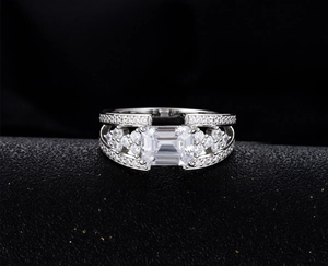 Macro detail of emerald cut zircon ring with micro-pave diamonds on split band