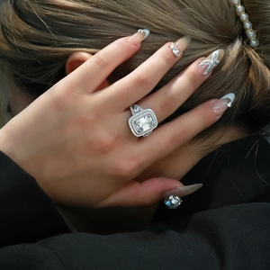 Emerald cut high carbon diamond ring with double halo and sparkling stones on silver band