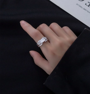 Detailed macro view of an emerald cut rectangular stone with hollowed diamond band