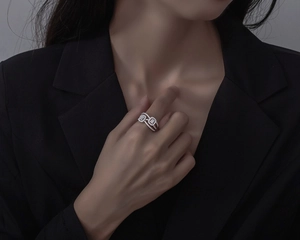 Macro shot of S925 silver layered crisscross ring with pavé micro-set square zircons