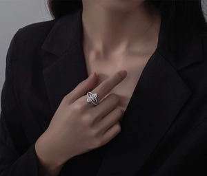 Close-up of sparkling micro-pave teardrop silver ring on model with black suit