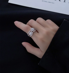 Detail of a multi-layer S925 silver ring featuring two micro-pave square zircon motifs