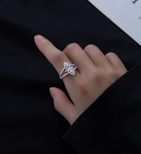 Detailed close-up of 925 sterling silver ring with micro-pave diamonds on hand