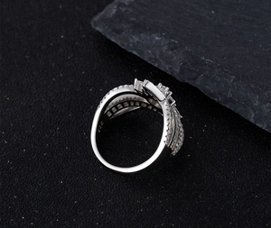 Macro detail of S925 sterling silver stamp and channel-set cubic zirconia on cross ring