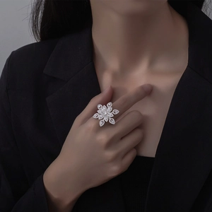 Dramatic S925 silver flower ring with micro-paved crystals worn on a hand