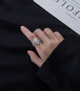 Close-up of S925 silver channel-set zircon ring on model with blue fabric background