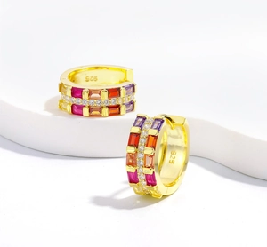 Close-up of 925 silver huggie hoop earrings with three rows of colorful zircon stones