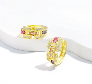 Macro shot of 925 silver gold earrings with colorful baguette stones and S925 stamp
