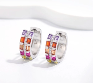 Detailed close-up of rainbow zircon huggie earrings in 925 silver with tri-row pavé setting