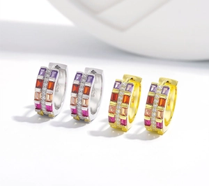 Macro detail of rainbow zircon earrings in silver and gold with clear 925 hallmarks