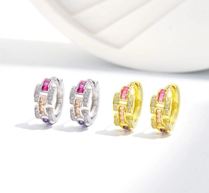 Macro detail of S925 sterling silver hoop earrings with colorful crystals and zircons