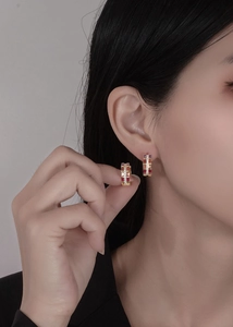Macro shot of 18k gold plated hoop earrings featuring multi-color rectangular zirconia