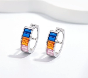 Macro detail of S925 silver hoop earrings featuring blue, orange and pink rectangle zircons