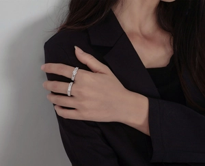 Detail of s925 silver rings with micro-pave cubic zirconia on female model hand