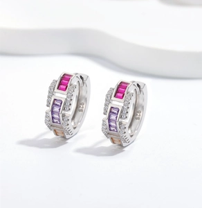 Detail of 925 sterling silver hoop earrings with multicolored rectangular gemstones