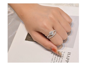 Vue détaillée d'une bague en cristal rose en forme de cœur sur la main