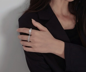 Detail of silver S925 sterling silver rings set featuring Cuban link design and crystals