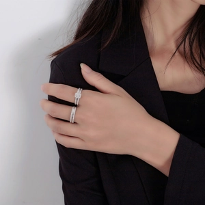Detail of S925 sterling silver ring set featuring square cut zircon and pavé band