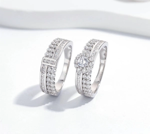 Close-up of S925 sterling silver couple rings with micro-paved diamonds and round center stone