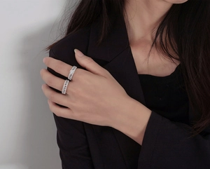 Detailed close-up of S925 silver wavy rings with sparkling cubic zirconia on hand
