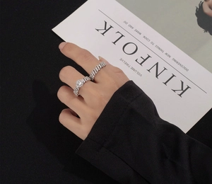 Close-up of S925 sterling silver ring set featuring a round diamond and Cuban chain link