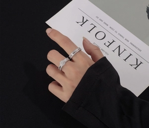 Close-up of S925 sterling silver stacked ring set with square zircon and micro-pave diamonds