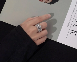 Close-up of luxury S925 silver multi-layer diamond ring with central round solitaire