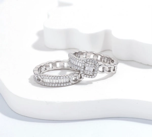 Macro detail of S925 silver chain rings set featuring baguette and round cut diamonds